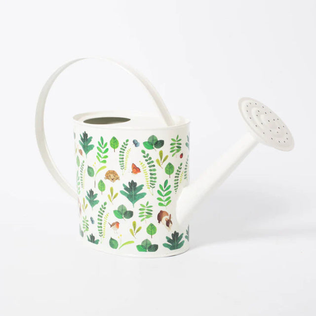 White watering can with green leaf pattern on a white background